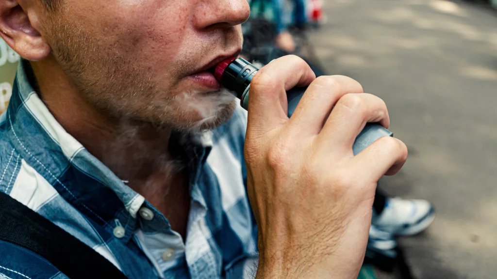 Person smoking using an electronic pipe