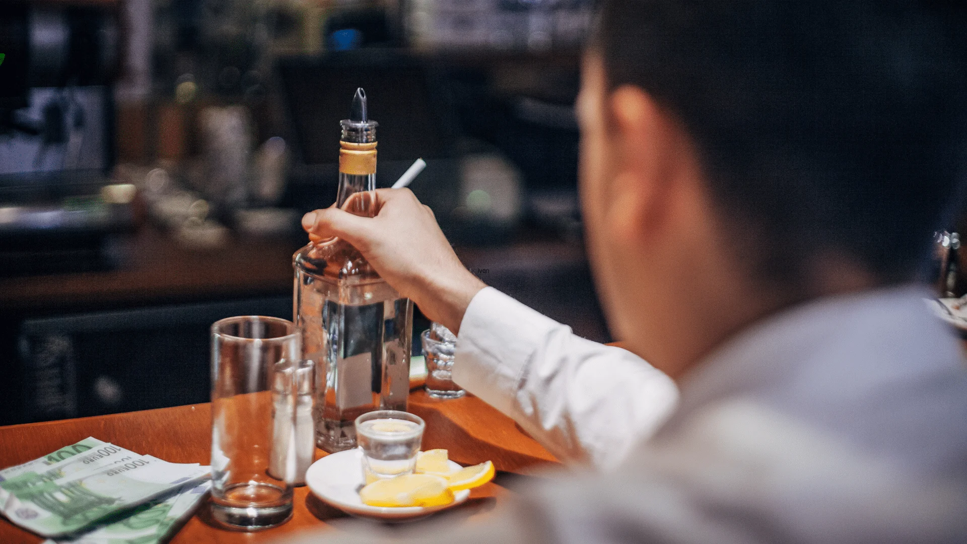 Is Tequila a Stimulant? Person holding a bottle of tequila