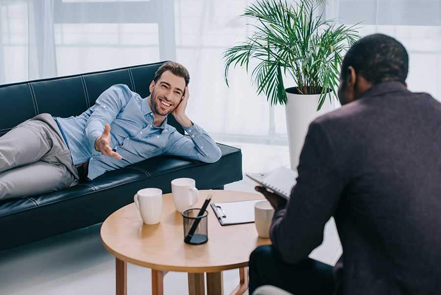 A man is happy during his therapy session all because he asked the question does aetna cover therapy