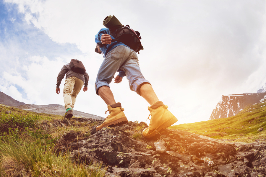 Discipline concept - Two hikers climbing a mountain