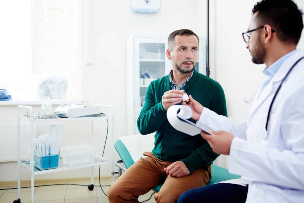 Patient receiving a prescription medication from a healthcare professional in a clinical setting, emphasizing the importance of consulting doctors about gabapentin and alcohol interactions.