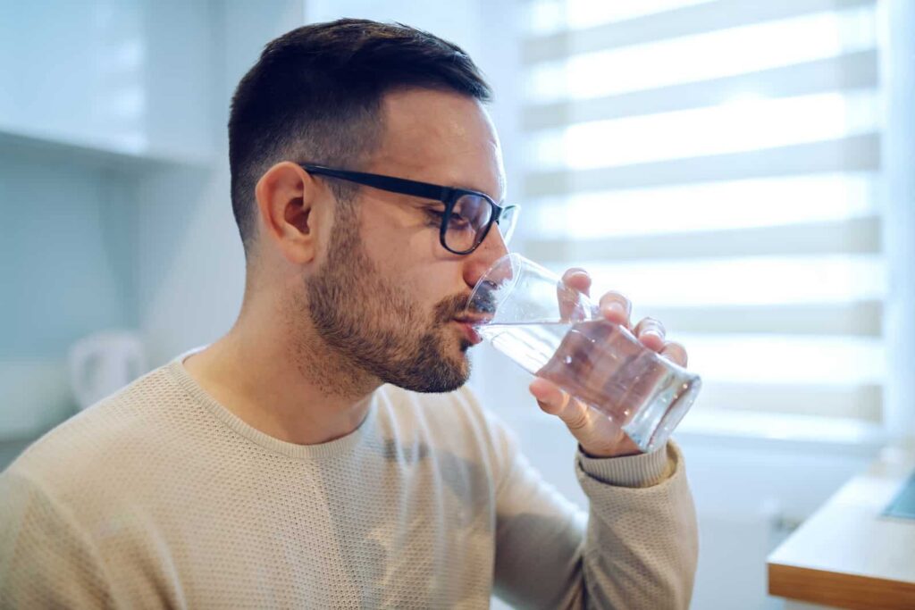 Man drinking water after taking benzodiazepines