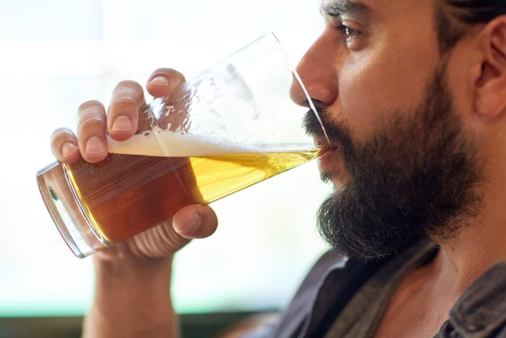 Person considering the dangers of mixing Tylenol&reg; with alcoholic drinks