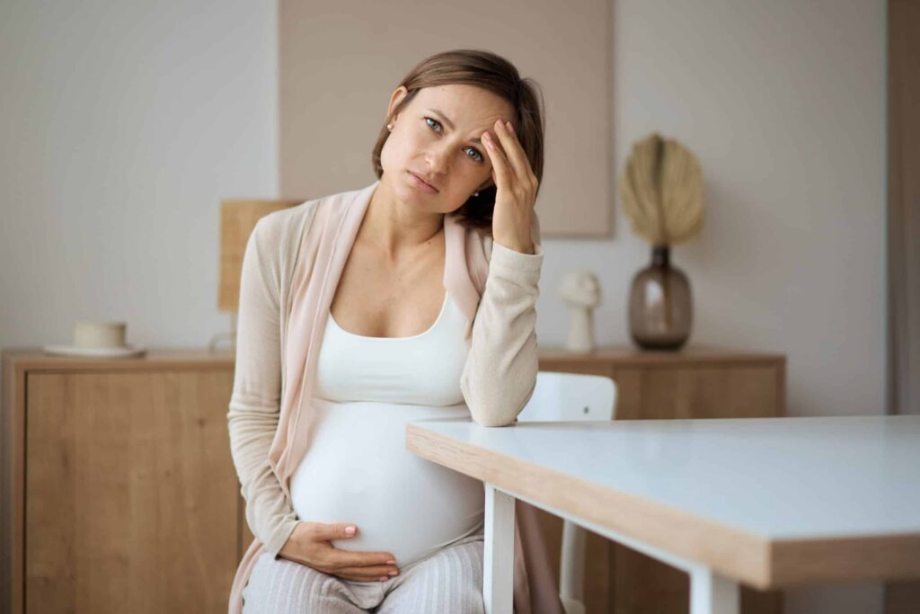 Expecting mother showing stress symptoms and considering Tums&reg; for relief