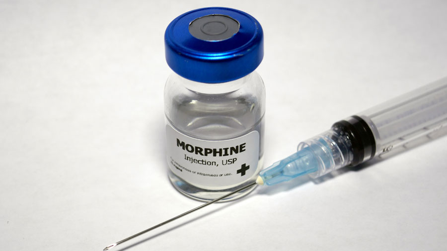 bottle of morphine next to a syringe. How Long Does Morphine Stay In Your System?