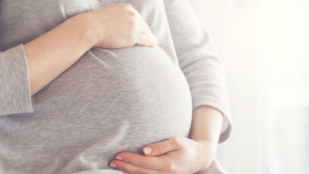 Pregnant woman consulting medication instructions for Xanax due to possible side effects