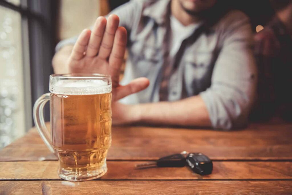 Man resisting mixing alcohol with his Adderall medication