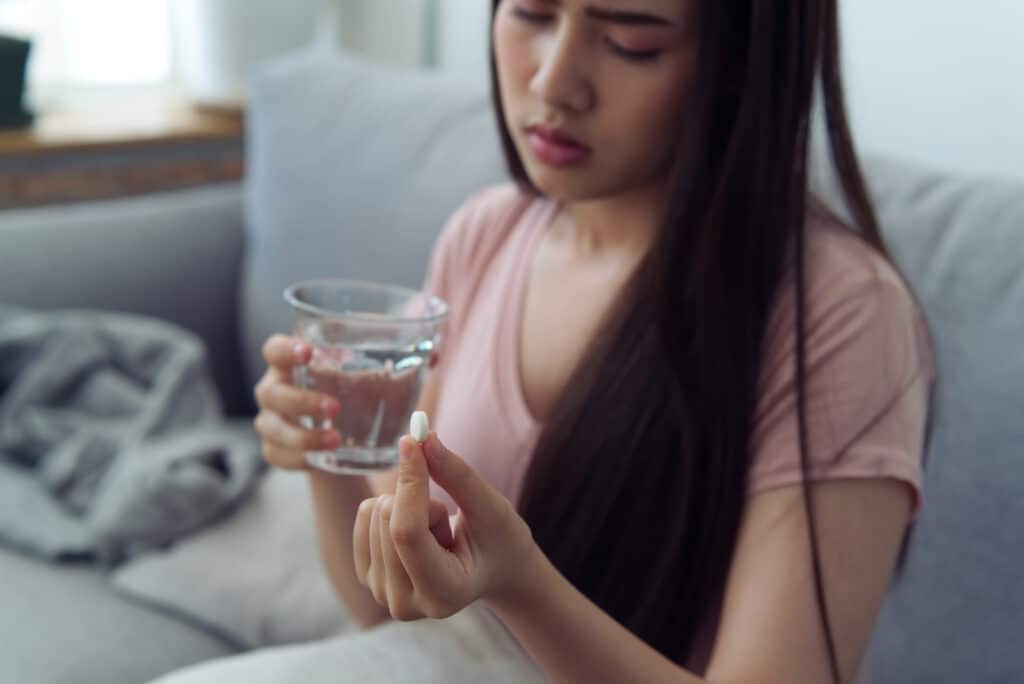 Woman holding trazodone while learning how long it lasts