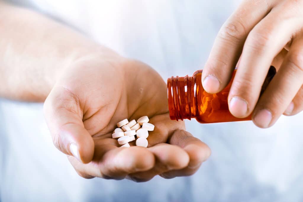 Man displaying Trazodone pills, symbolizing overdose