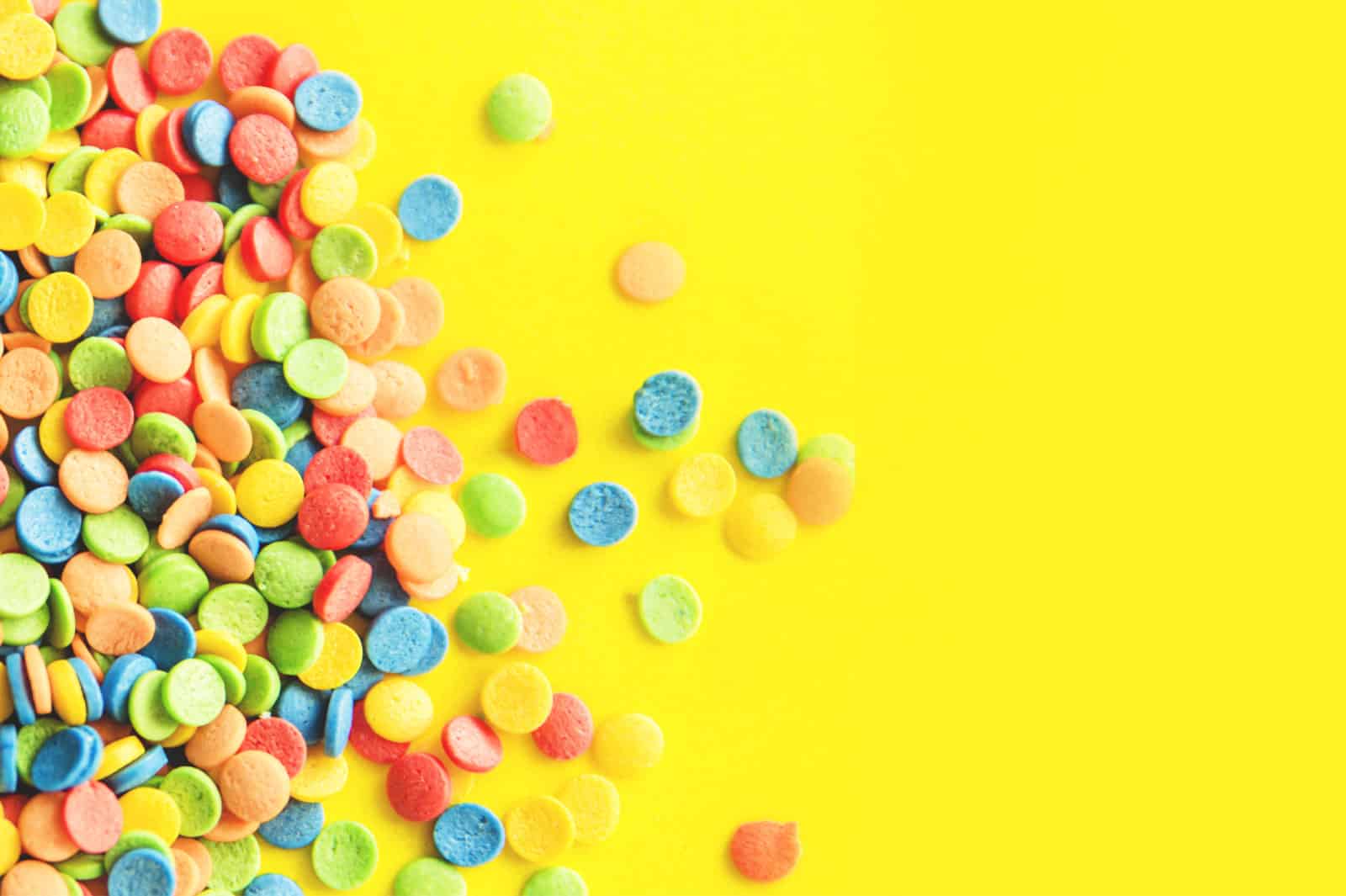 Several thin circles in multiple colors on a yellow background.
