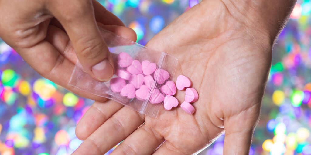 MDMA pills in a plastic bag, illustrating Molly and Ecstasy drug use and addiction.