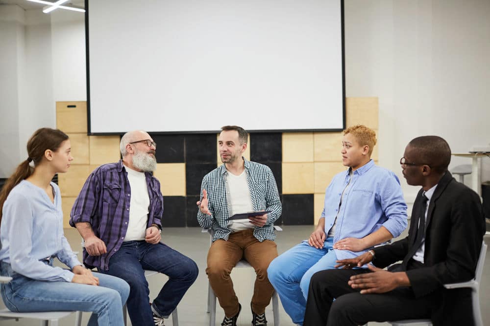 Group therapy session for MDMA addiction treatment and recovery.