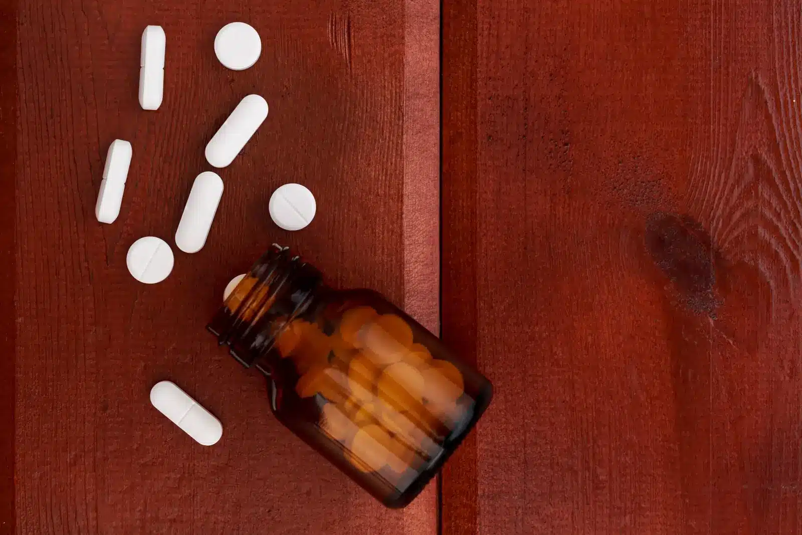 Tramadol withdrawal symptoms. Spilled bottle with white pills