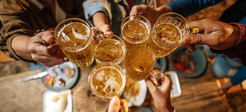 Multiple glasses of alcohol illustrating alcohol metabolism and addiction recovery.