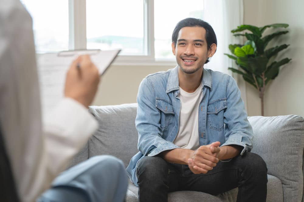 a man smiling at therapist in therapy session