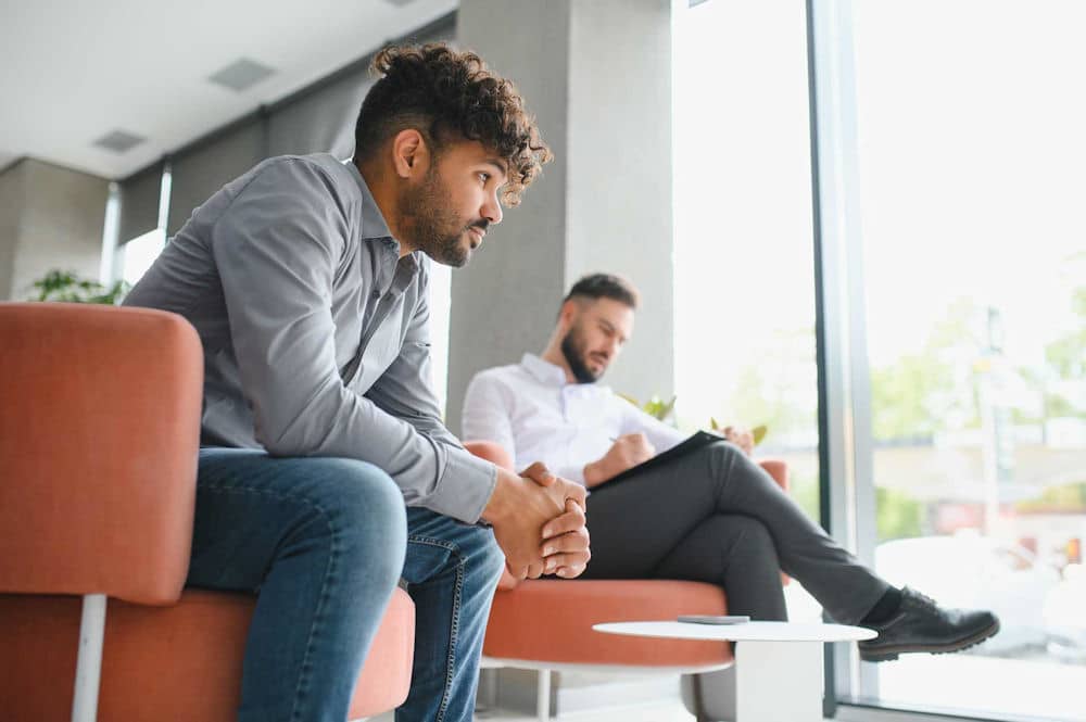 a man sitting down in therapy session