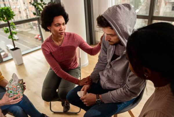 a man being comforted in therapy