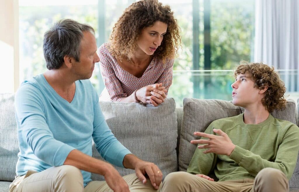 Group discussion in a comfortable setting, focusing on support for addiction recovery, with individuals engaged in conversation about treatment options.