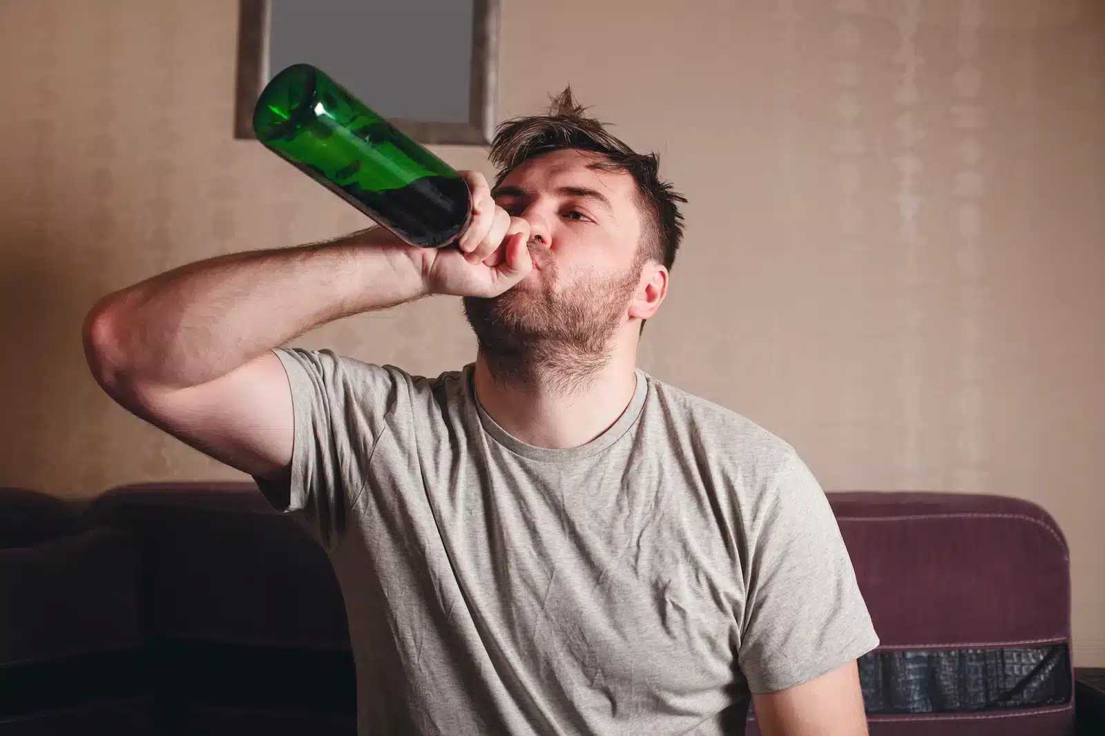 Man drinking from bottle illustrating end-stage alcoholism and alcohol dependence.