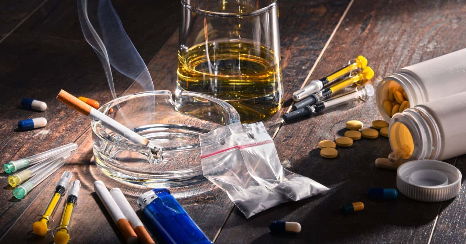 Alcohol, drugs, and cigarettes on a table